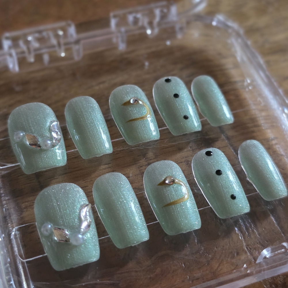 40. Mint Green Press-On Nails with Silver and Black Accents